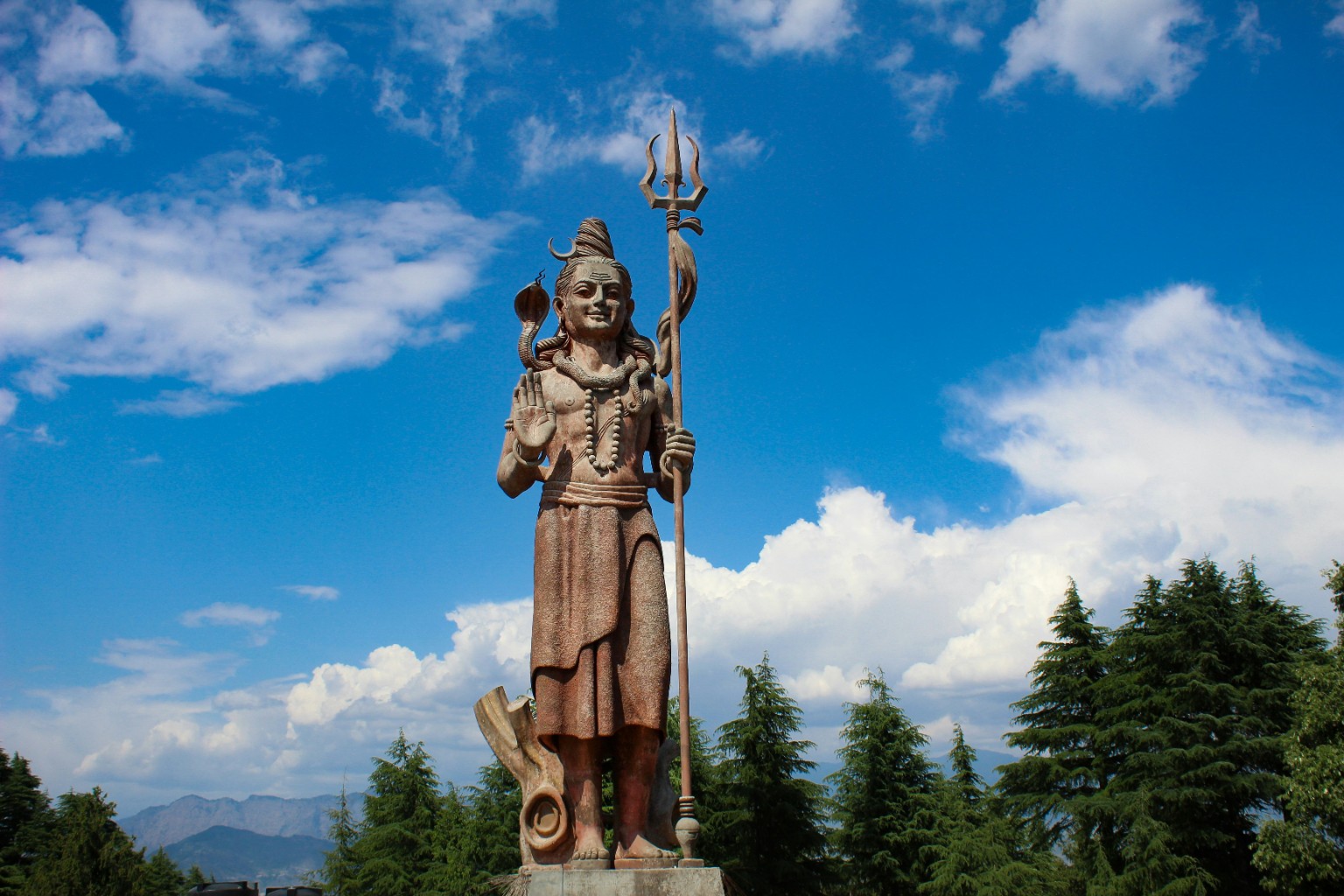 Shiva statue against a blue sky